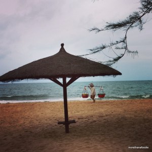 phu quoc beach fruit lady umbrella beach scene vietnam